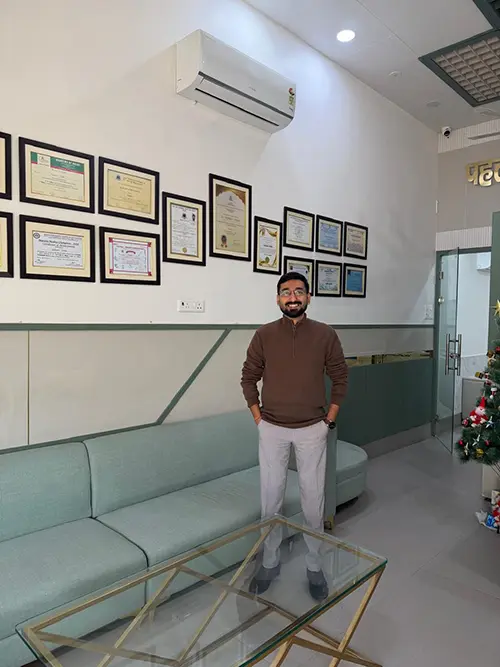 Dr. Yashasvi Verma standing in his clinic waiting area